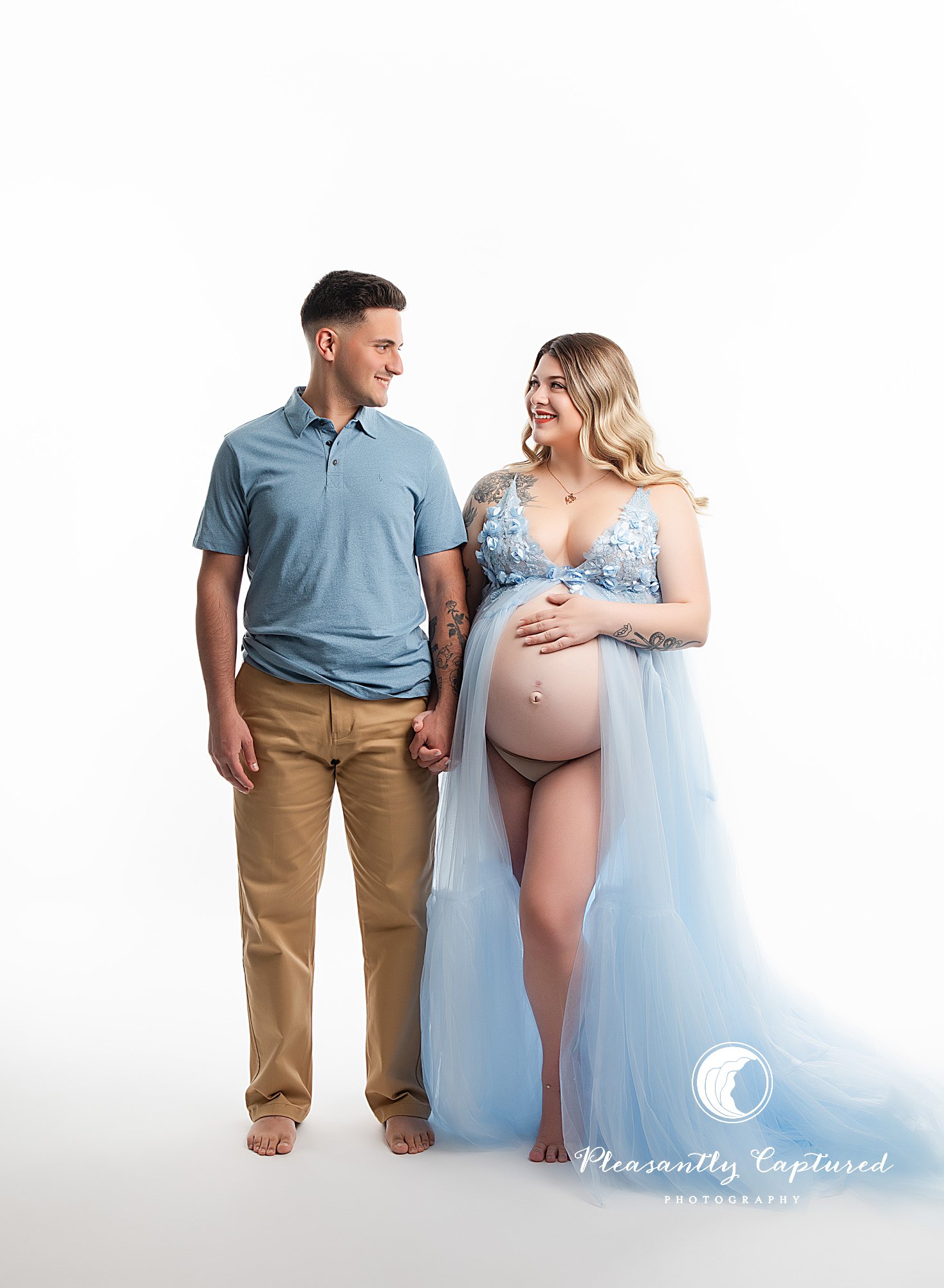 Expecting couple photographed in studio during maternity session